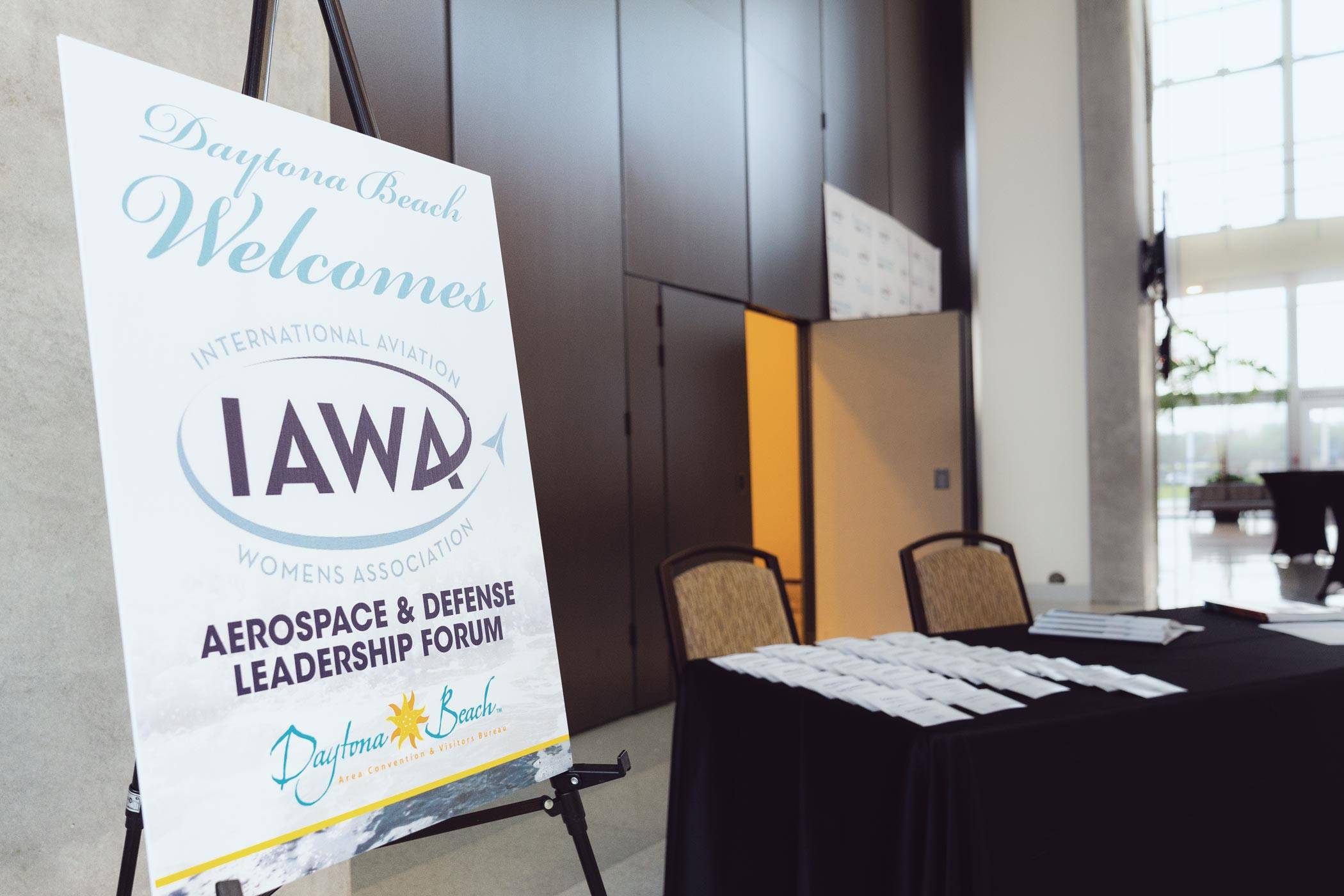 The sign in area for the IAWA conference with table and chairs.