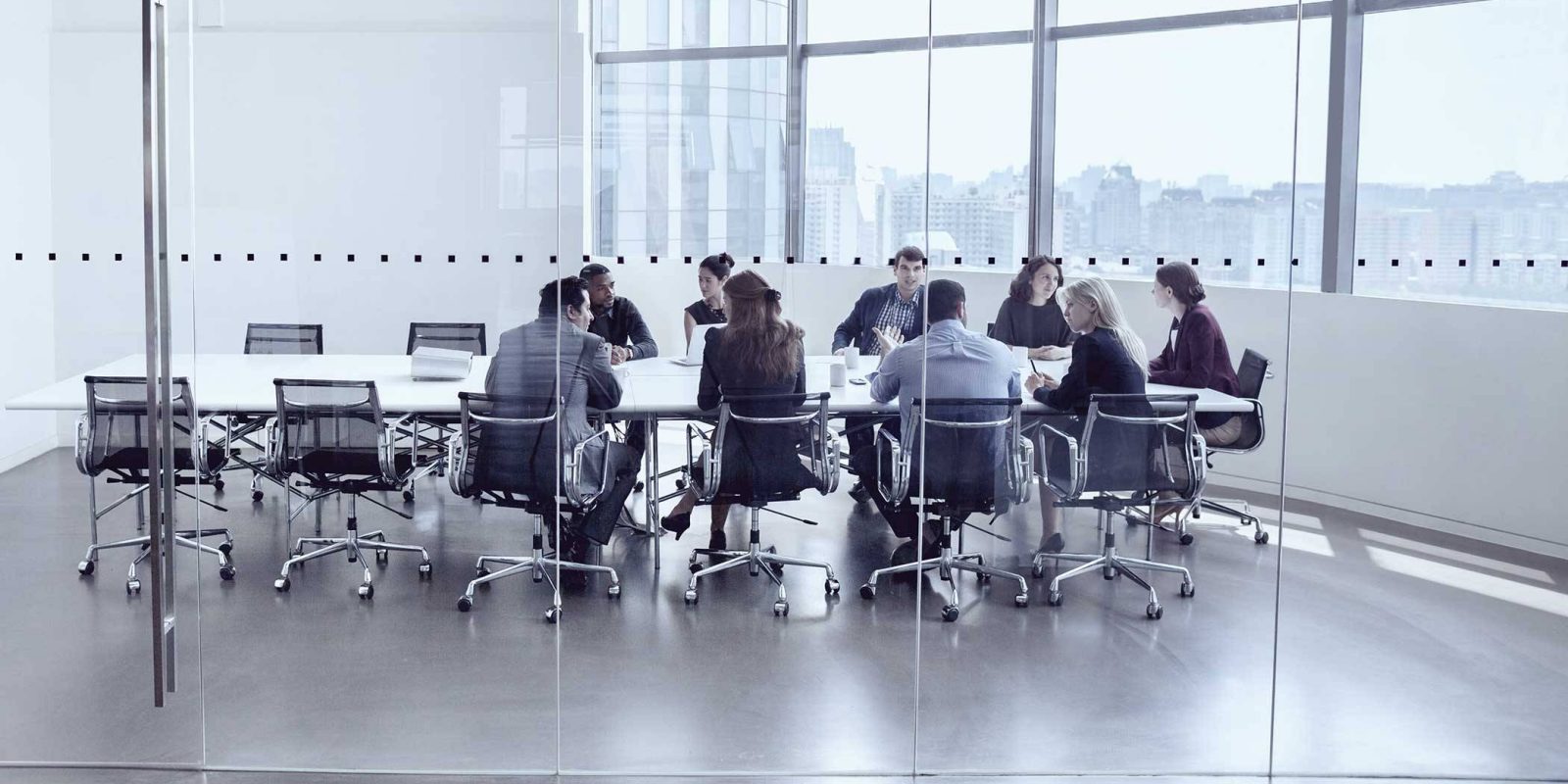 Group of business people sitting at a table having a meeting